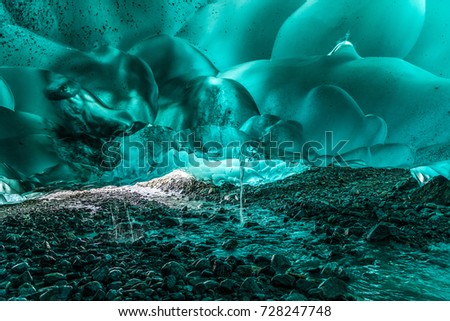 The rich colors of sunlight filtered by the thick ice of Mendenhall Glacier near Juneau, Alaska.