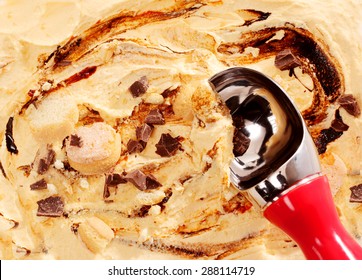 Rich Creamy Caramel Ice Cream With A Metal Scoop And Crunchy Chips Of Candy In A Close Up View From Above For A Full Frame Texture