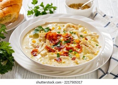 Rich And Creamy Soup Made With Tender Rotisserie Chicken Breast, Hearty Potatoes, Sweet Corn, Topped With Fried Crispy Bacon And Fresh Parsley In White Bowl