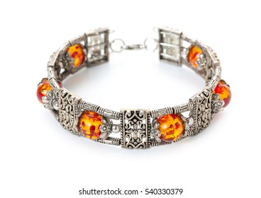 Rich decorated silver bracelet with amber. Bijouterie, imitation jewelry.