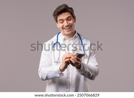 Similar – Image, Stock Photo Rich Doctor Man with Usd money. Handsome Medical Health Care Worker In White Coat with salary, payment. Jackpot, win