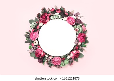 Rich Floral Wreath Frame With Roses And Peony In Bloom On Tender Pink Background With White Mockup Circle Text And Copy Space. Festive Flat Lay.