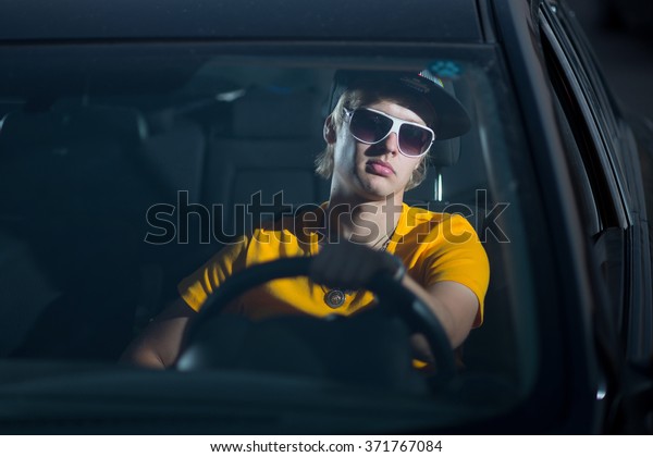 a rich guy in a car, cool\
dude