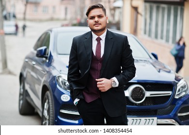 Rich Indian Businessman In Formal Wear Standing Against Business Suv Car.