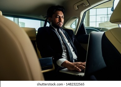 Rich Indian Businessman In Formal Wear Drive Car .