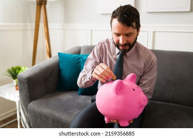 Rich Man With Financial Security And Stability Putting Money On A Piggy Bank For His Savings