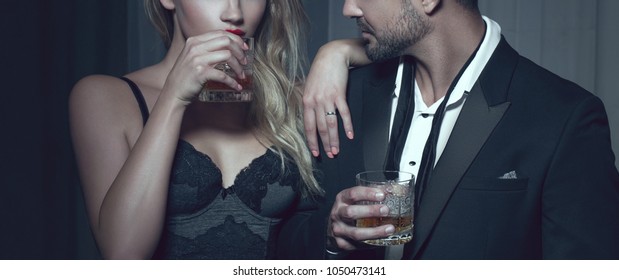 Rich man with lover with drink in night club, cinematic style