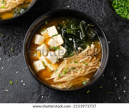 Rich miso soup with enoki mushrooms, wakame seaweed and tofu, vegetarian, vegan Asian food.