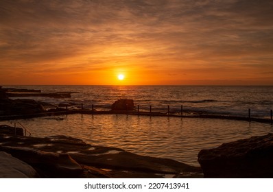 Rich Orange Sunrise Over Rock Pool Maroubra In NSW Australia