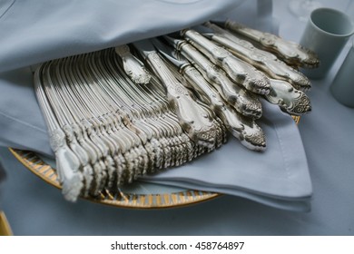 Rich Steel Flatware Lies In A Blue Napkin