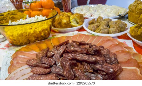 Rich table spread with many different dishes, fruits and deserts.