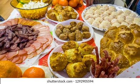 Rich table spread with many different dishes, fruits and deserts.