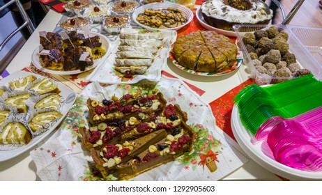 Rich table spread with many different dishes, fruits and deserts.