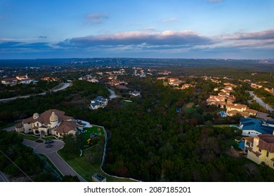 Rich Wealthy Million Dollar Mansions over Austin Texas during amazing Sunset over West Lake hills with nice luxury living suburbs surrounding Central Texas Hill Country