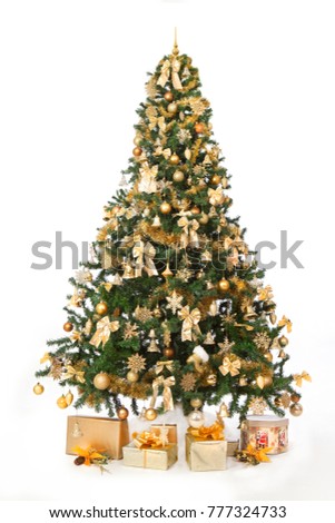 Richly decorated christmas tree with golden ornaments, isolated with a white background and a presents for a new year. Vertical studio  shoot. 