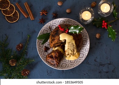 Richly Spiced Christmas Pudding Cake With Custard. Christmas And New Year Table, Decorations. View From Above, Top Studio Shot