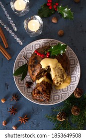 Richly Spiced Christmas Pudding Cake With Custard. Christmas And New Year Table, Decorations. View From Above, Top Studio Shot