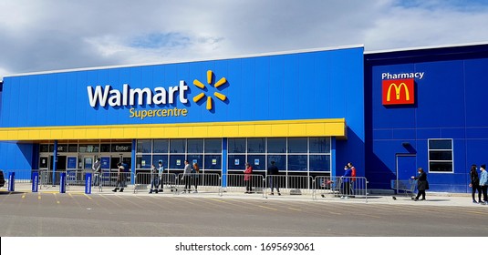 RICHMOND HILL, CANADA - APRIL 6, 2020: Shoppers line outside a Walmart store in Ontario.