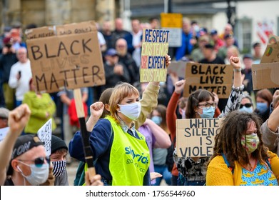 Richmond, North Yorkshire, UK - June 14, 2020: Black Lives Matter protesters wear PPE Face Masks and hold homemade signs at a BLM protest in Richmond, North Yorkshire