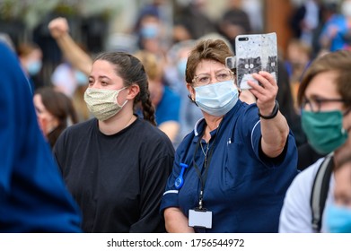 Richmond, North Yorkshire, UK - June 14, 2020: A Care Worker Wears A PPE Face Mask And Takes A Selfie At A Black Lives Matter Protest In Richmond, North Yorkshire