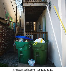 Richmond, VA / USA - Aug 19, 2019: Trash Cans Overflowing Behind A Residential House In An Alley Way In The Neighborhood Of Carytown. 