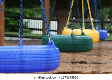 Richmond, Virginia/USA - June 22,2009: Empty playground with colorful children's swings from old tires. Recycled tires, eco-friendly.