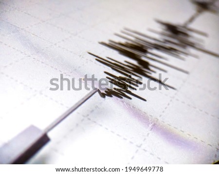 Richter scale Low and High Earthquake Waves with Vibration on white paper background, audio wave diagram concept, photo of cellphone screen, Aceh Indonesia Foto stock © 