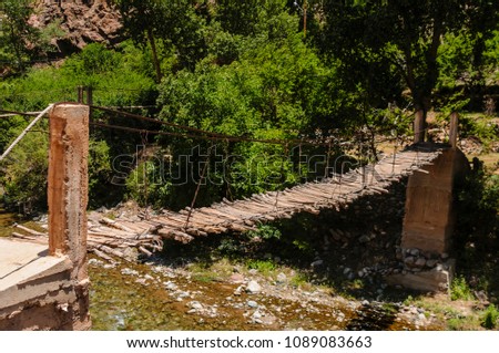Rickety wooden bridge over the River Ourika high up in the Atlas Mountains, Morocco