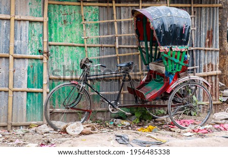A rickshaw parked near road . 