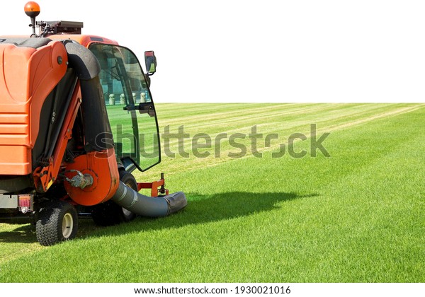 Ride on lawn mower cutting fresh grass - Image\
with copy space.