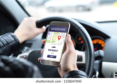 Ride share driver in car using the rideshare app in mobile phone. New taxi ride request from customer in smartphone application. Man picking up passengers for online carpool service.