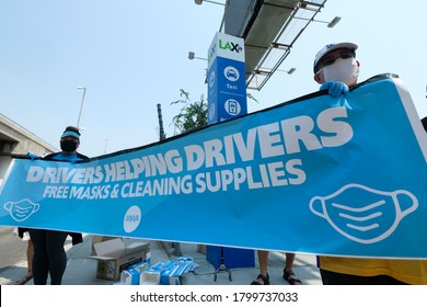 Ride share drivers carry a banner during a rally calling for basic employment rights at LAX on Thursday, Aug. 20, 2020 in Los Angeles. 