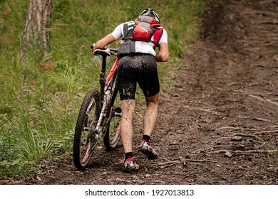 Rider Cyclist With Mountain Bike Uphill Climb On Forest Trail