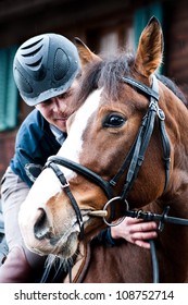 Rider With A Helmet Sitting On A Horse