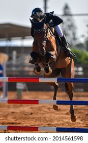 Rider on horse jumping over a hurdle during the equestrian event