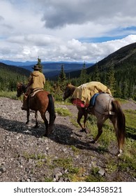 A rider with pack horse riding the backcountry. 