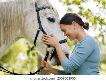 Rider, woman and bonding with horse in forest for companion, training and relax from practice outdoor. Equestrian, happy person and stallion in countryside with embrace, pet care and agriculture - Powered by Shutterstock