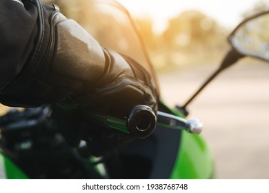 Rider With Your Hand On The Throttle Or Brake On The Handlebar Of Your Motorcycle And Your Protective Gear On. Copy Space.