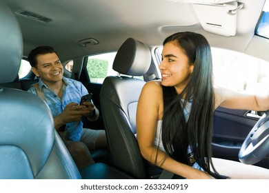 Rideshare driver and client engaging with a mobile phone app while inside a car, navigating through the urban landscape for convenient travel