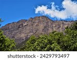 The ridge and summit of Mount Meru, a dormant stratovolcano and the second highest mountain (4562 m) in Tanzania, as seen from the hiking trail in the vicinity of Miriakamba Hut (Arusha Region)