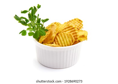 Ridged potato chips in bowl, isolated on white background. High resolution image.