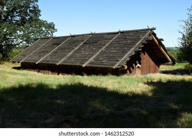 Ridgefield, WA – July 26, 2019: The reconstructed full scale Chinookan plankhouse, Cathlapotle, at the Ridgefield National Wildlife Refuge. Constructed of Western Red Cedar planks.