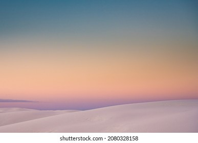 Ridges Of Sand Dunes On The Horizon With Pastel Colors Fading Together At Sunset In New Mexico Park