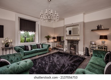 Ridgewell, Essex - May 11 2016: Furnished Traditional Drawing Or Sitting Room Within Old Renovated Former Victorian Rectory With Green Velvet Sofas And Armchairs