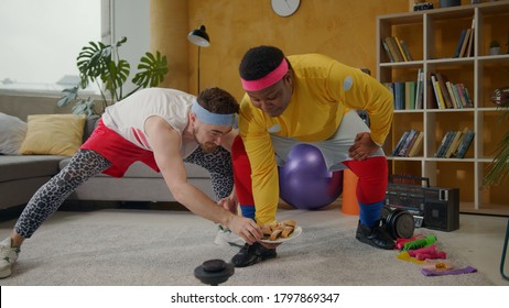 Ridiculous Amazing Multi-ethnic Weak Men Lifting Plate With Cookies. Weird Fitness Comical Guys Lifting Weights Playing Freaks On Workout Home Training.