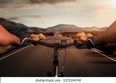 Riding a bicycle on an empty highway through the volcanic landscape with copy space