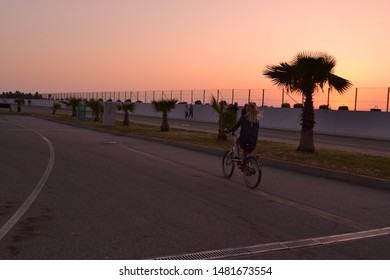 Riding bicycle while the sun is setting