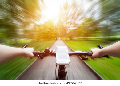 Riding A Bike First Person Perspective. Smartphone Attached To Handlebar. Speed Motion Blur. Countryside Road Towards Sun.