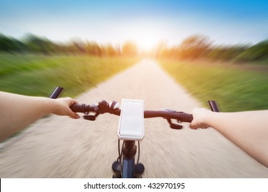 Riding A Bike First Person Perspective. Smartphone Attached To Handlebar. Speed Motion Blur. Countryside Road Towards Sun.