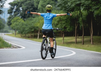 Riding bike with hands free in park - Powered by Shutterstock